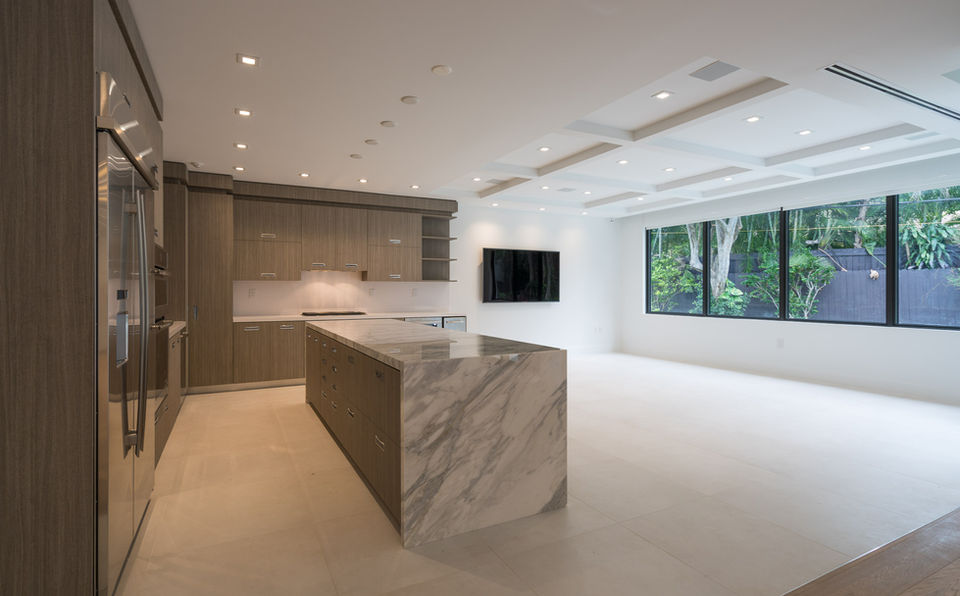 Modern kitchen and living area with marble island