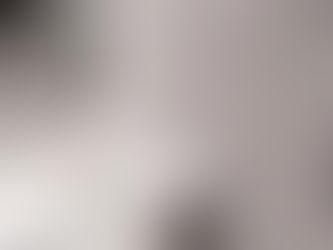 Textured woven wallpaper with a gray pattern beside a marble countertop in a modern setting. No text visible. Calm and elegant mood.