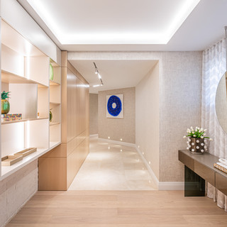 Hallway with art, mirror, and furnishings featuring The Wallpaper Company.