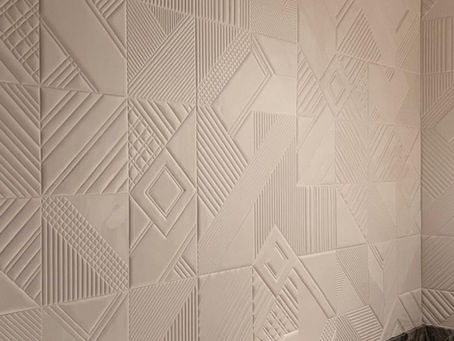 Installation of GUH31104 3D geometric acoustic wallpaper near me in a Fisher Island powder room, featuring a raised bone-white pattern behind a dark marble vanity.