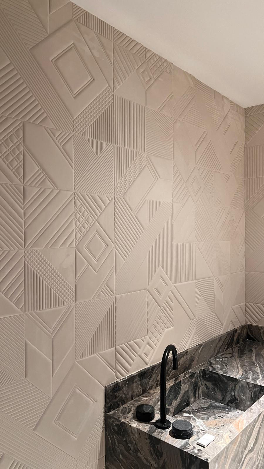 Installation of GUH31104 3D geometric acoustic wallpaper near me in a Fisher Island powder room, featuring a raised bone-white pattern behind a dark marble vanity.