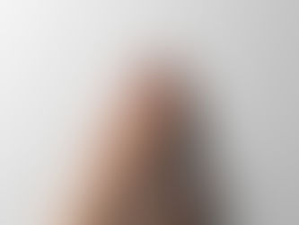 A hand touching a smooth, light gray wall, with fingers gently spread. The close-up image conveys a sense of calm and simplicity.