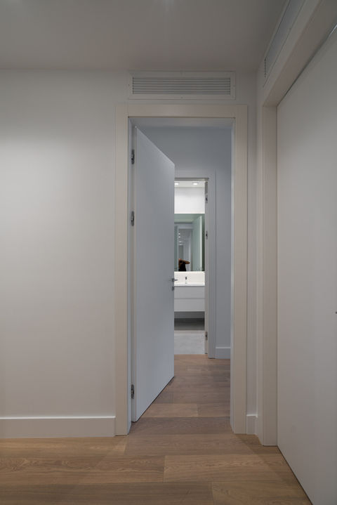 Open door revealing modern bathroom