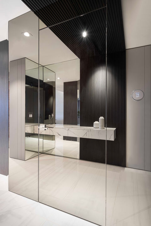 Modern minimalist entryway with large mirror
