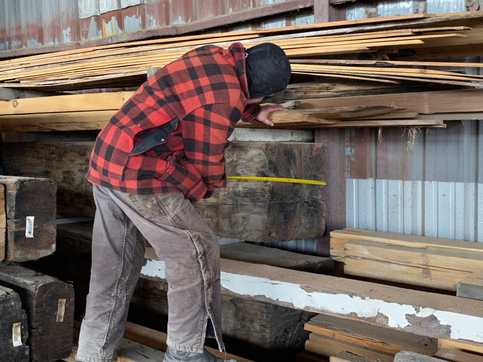 Bruce Gerrie measuring white oak reclaimed timbers.