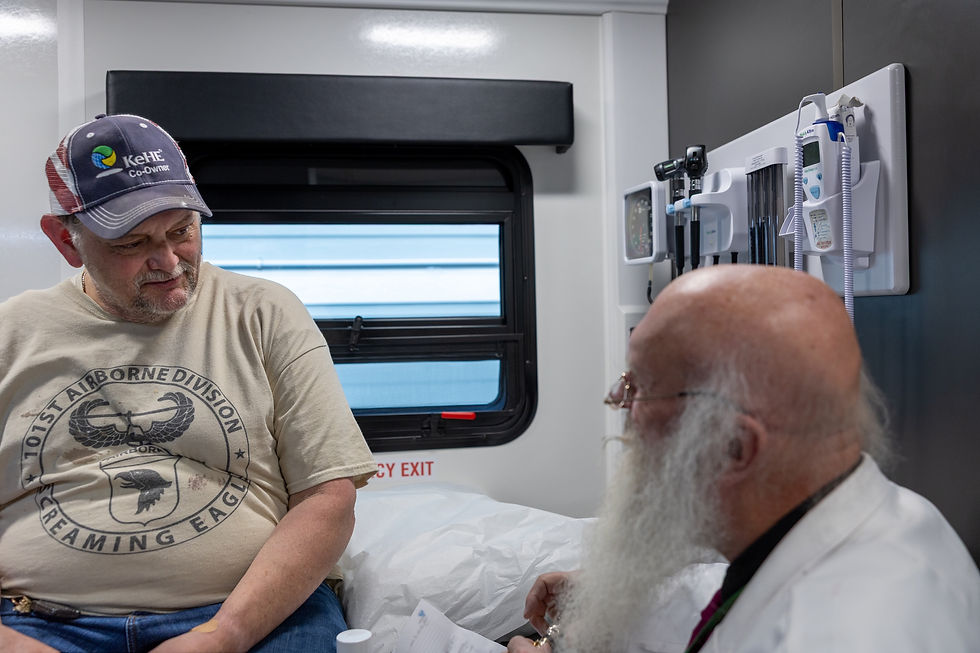 Dr. John S. Culp treats a patient inside the St. Mary's Health Wagon.