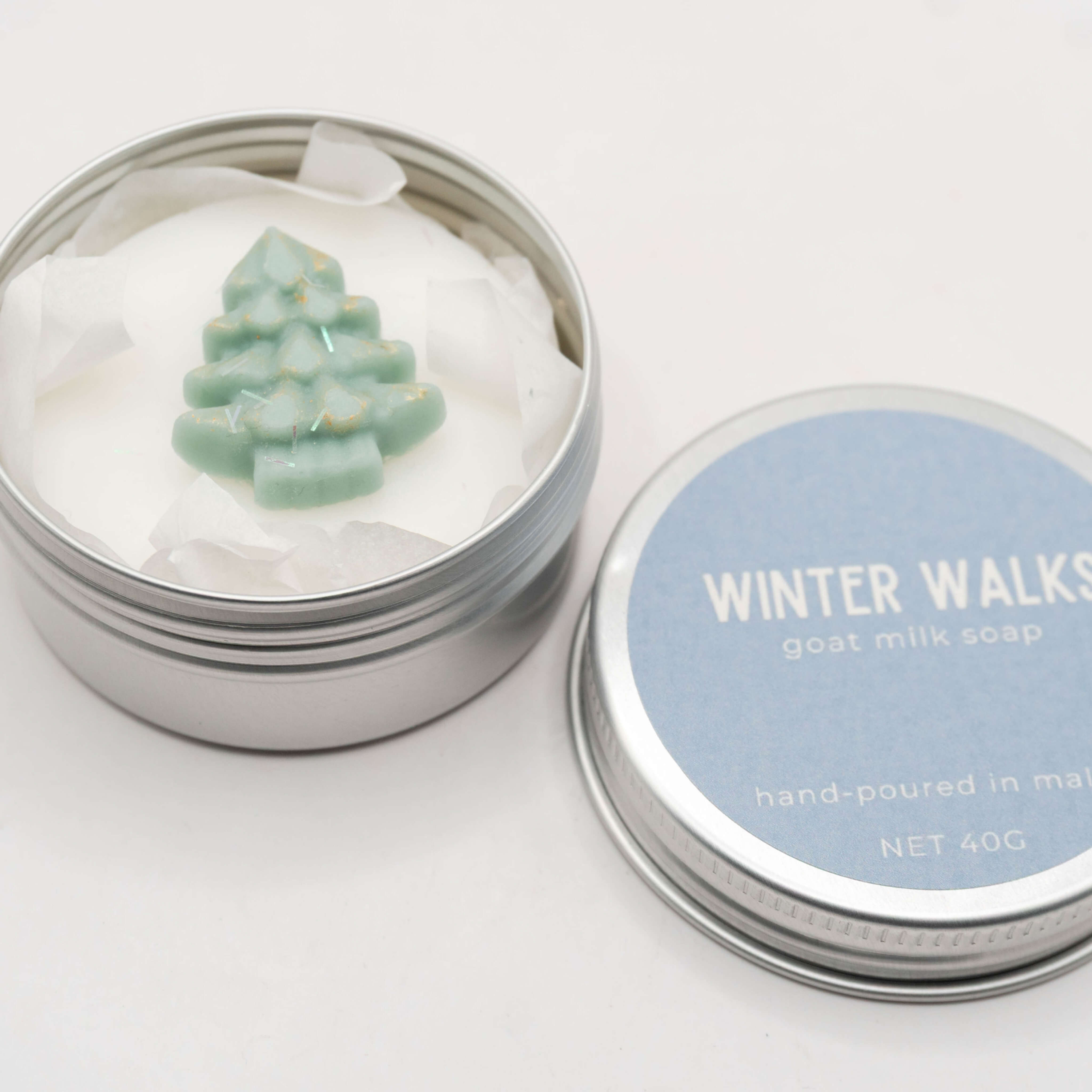 Winter Walks goat milk soap with a festive design in metal tin