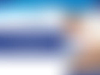 Healthcare worker assisting a patient. Text reads "Ultimate guide to ICD-10-CM Codes F01-F99." Blue and white geometric design.