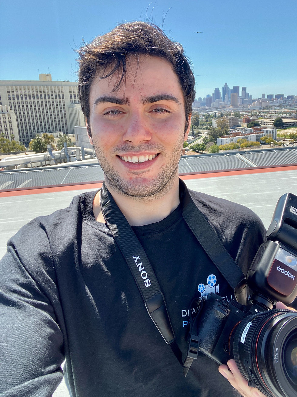 Man holding a photography camera on top of a helicopter pad 