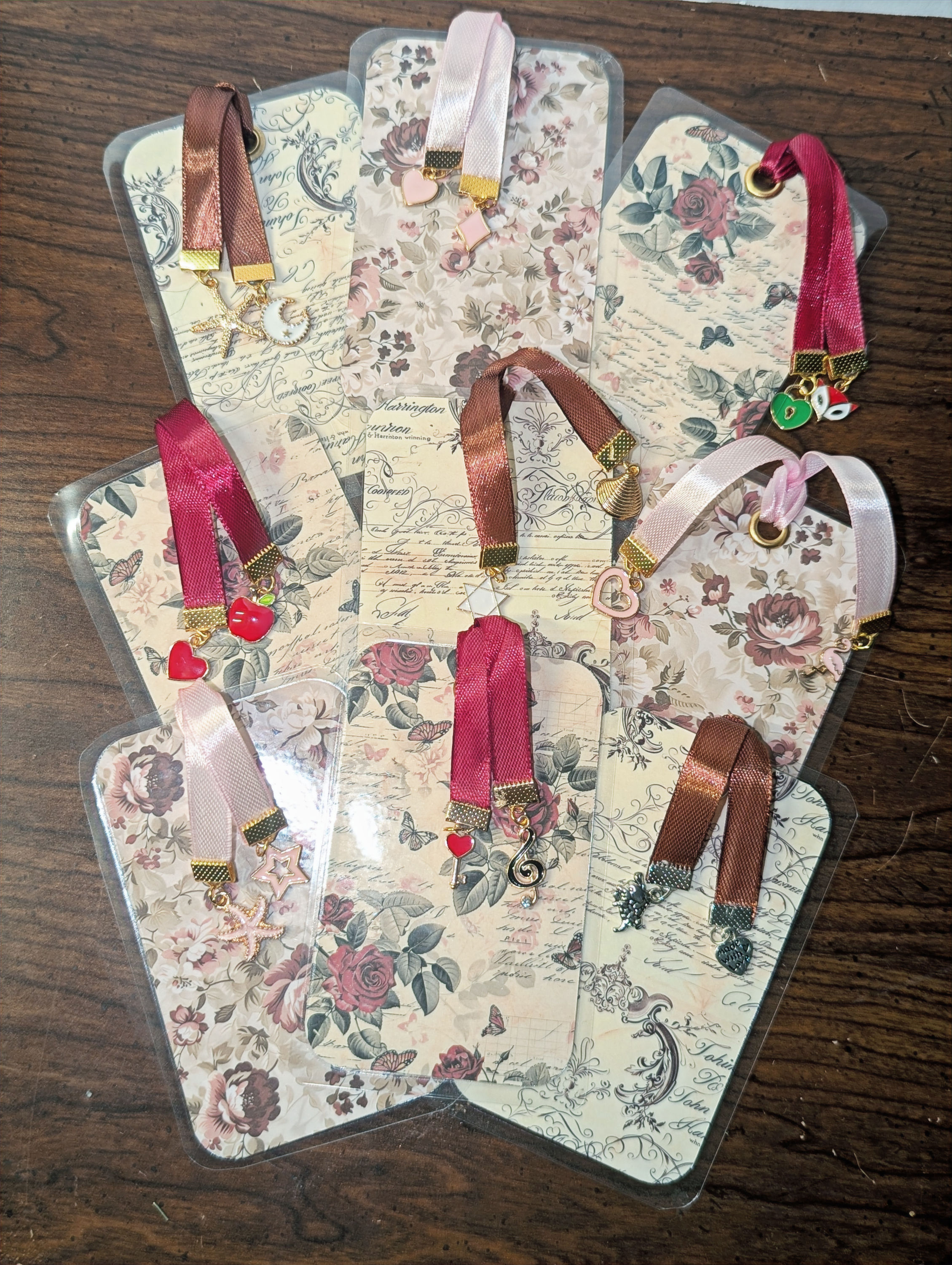 All three handmade floral bookmark sets shown together, 3x4 bookmarks with ribbon and jewel charms