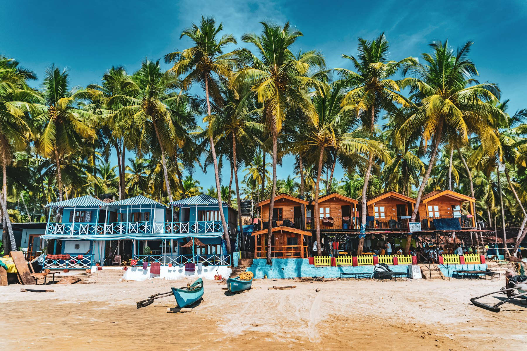 Colourful beach huts and palm trees in Goa