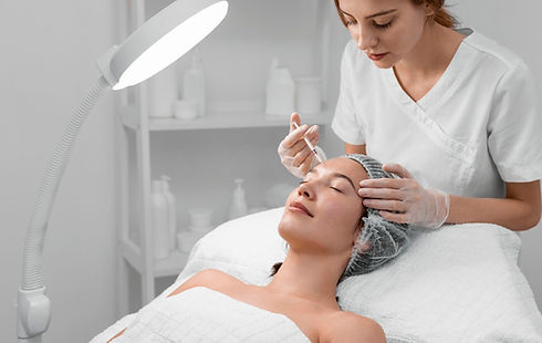 Woman receiving facial treatment at spa