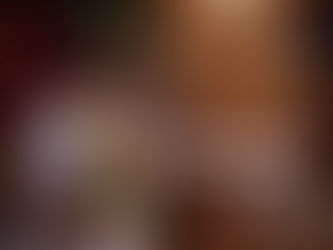 Stack of sugar-coated gingerbread-style cookies filled with cream cheese on a small wooden stand, styled with Christmas decor including pinecones, greenery, and a festive illustrated card beside them.