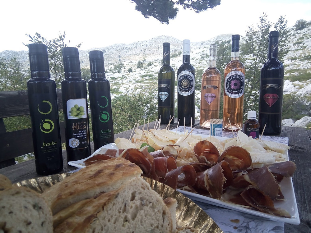 Enjoying the meal in the mountains: Olive oil, wine, cheese, prosciutto and homemade bread
