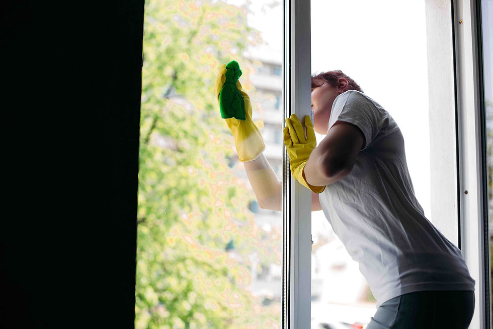 a myanmar maid cleaning a exterior window.