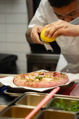 grating lemon on the pink pizza