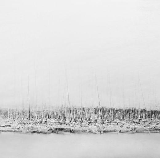 In this modern black and white fine art wall art icm photography and multiple exposure photo print of sailboats in the Oslo harbour, all beneath a dramatic sky by Douglas Carr Photography taken with Fuji GFX100Sii