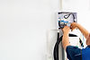 Certified male Electrician Installing Home EV Charger.jpg