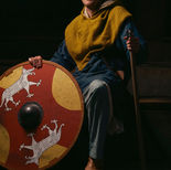 "Ulfhedinn Viking reenactor in traditional wool tunic with round shield"