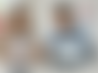 A woman holds a medical form while a man points at a laptop showing "Express Entry." Canadian flag and sign in background. Office setting.