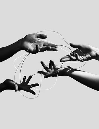Two pairs of hands facing each other and holding wires and balancing them