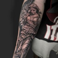 Detailed black and white angel tattoo on forearm