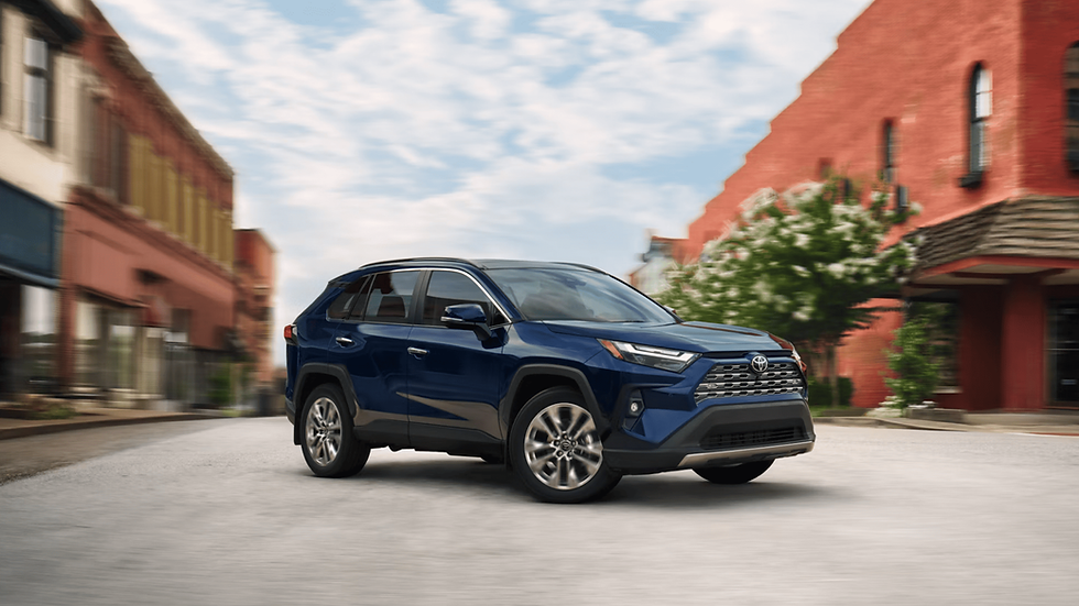 Dunkelblaues Toyota SUV fährt durch eine malerische Stadtstraße, sonnigen Tag.