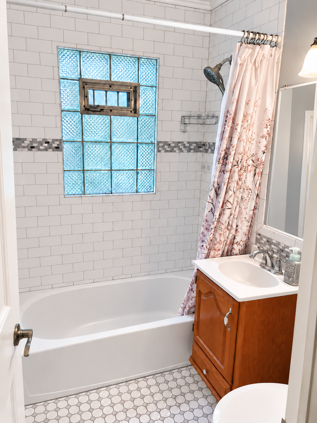 Bathroom before conversion, with bathtub and glass-block window