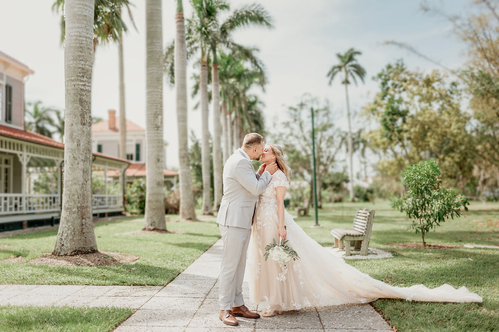 Bride and Groom kissing on path under palm trees