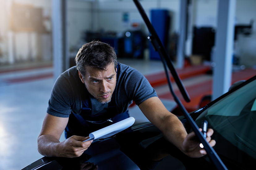 car-mechanic-examining-vehicle-problems-while-working-auto-repair-shop.jpg