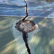 cracked tennis court net posts
