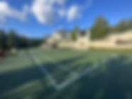 finished green tennis court mansion