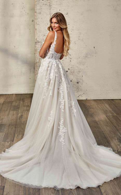 Eddy K wedding dress with beaded lace with sequins, 3D appliqués, tulle, unlined bodice, slit, buttons to end of train on woman.