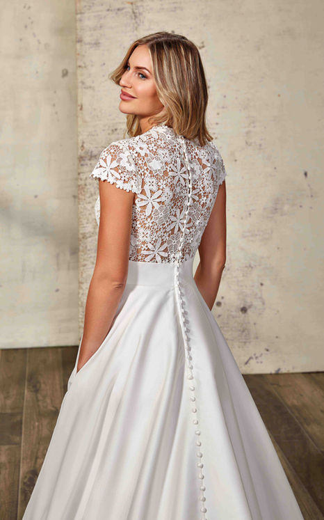 Back of woman on studio wearing an Eddy K mikado wedding ballgown with all over lace unlined bodice.