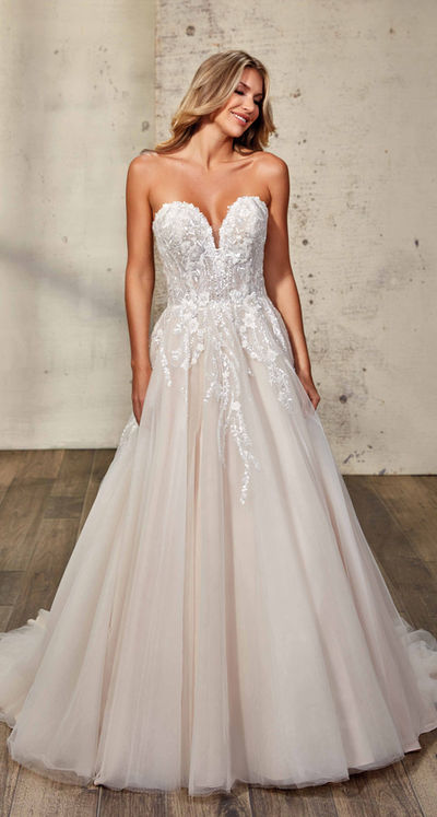 Eddy K model in a studio wearing a strapless A-line wedding dress.