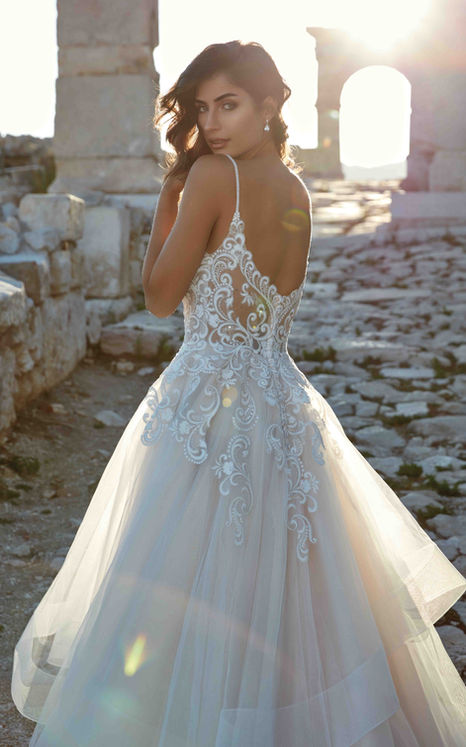 Back of Eddy K Ballgown Genova wedding dress with ivory lace with spaghetti straps on brown haired model.