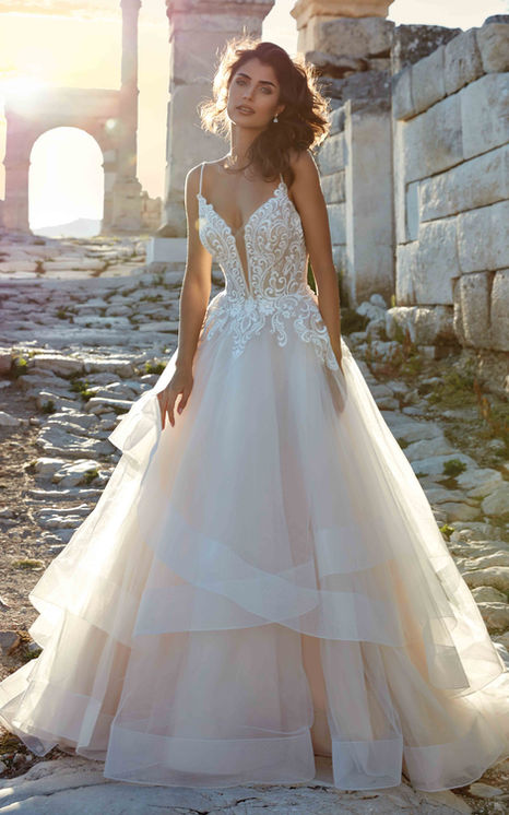Eddy K Genova Ballgown wedding dress with ivory lace, sequins and tulle layered skirt with spaghetti straps on brown haired model.