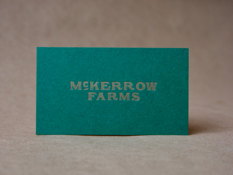 “Luxury letterpress business card with deep impression and gold metallic ink, printed on dark green paper stock in Minneapolis.”