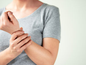 Menopausal woman rubbing joints in pain