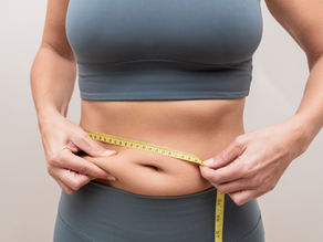 Woman checking her menopause belly fat