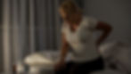 Middle age woman gently holding her back, indicating joint discomfort in aging.