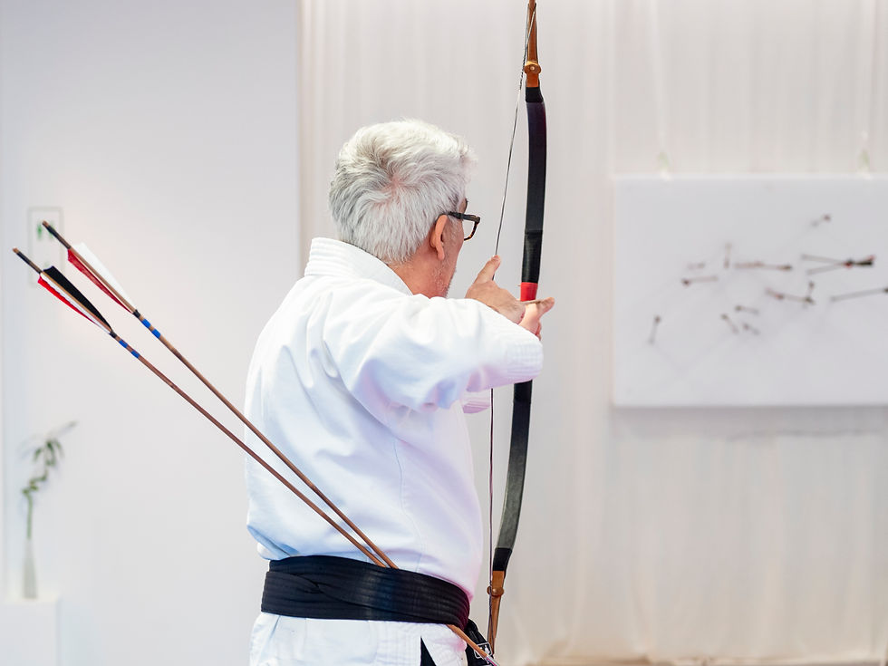 Close-up view of an archer aiming at a target in an indoor range