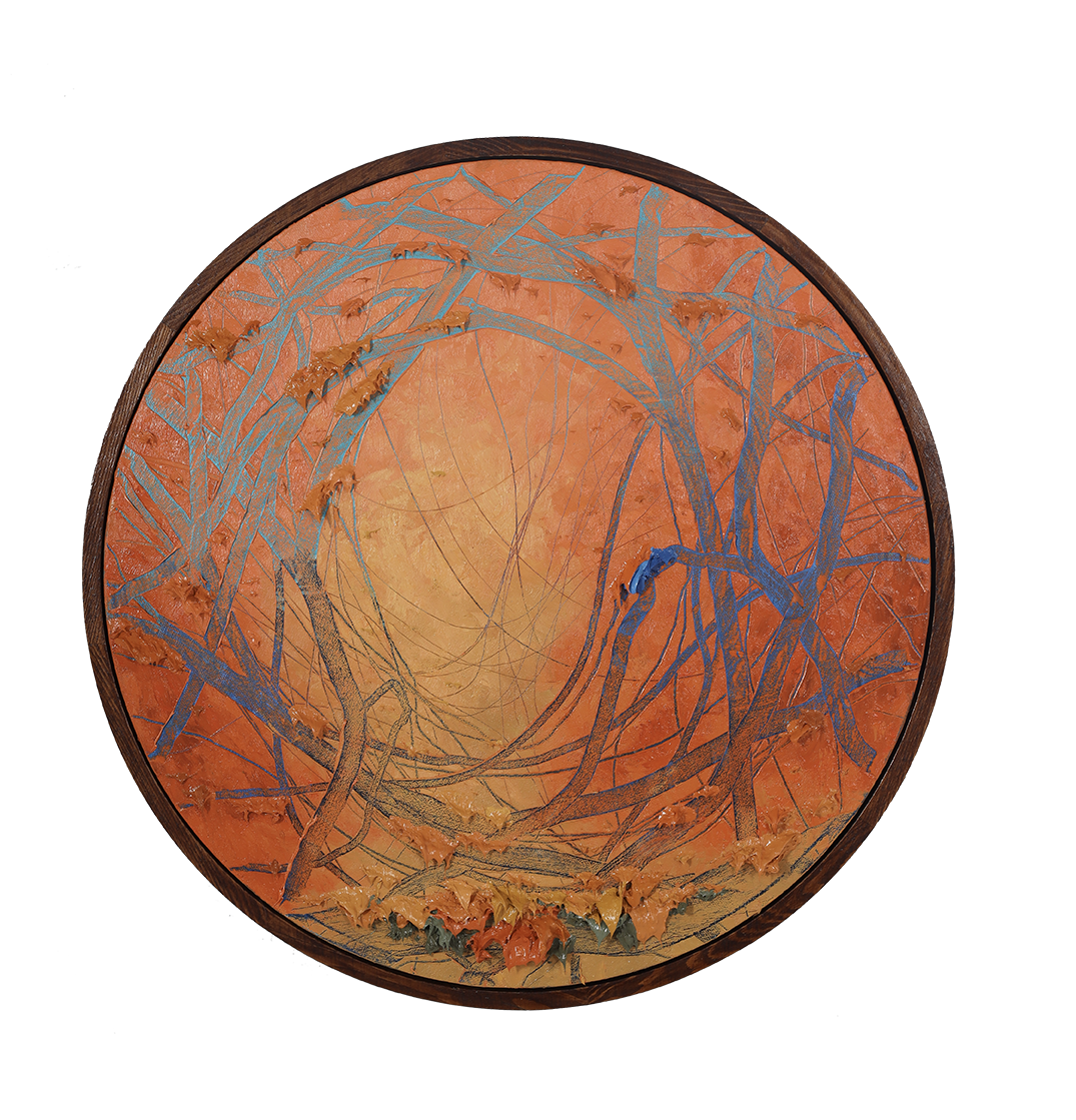 Orange round abstract painting hanging on the wall.