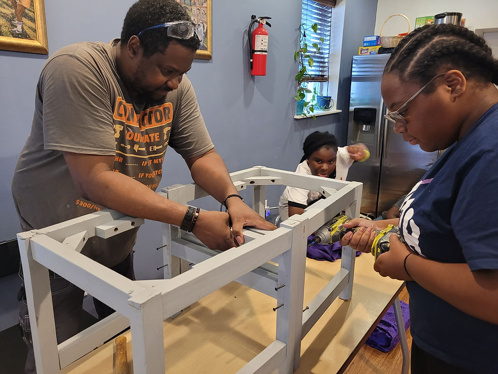 Close-up view of a volunteer helping a young person with a project