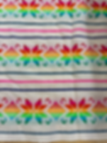 white mexican fabric with multicolor design front view