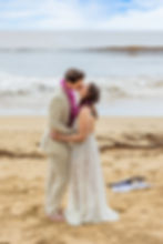 Couple kisses on Hapuna Beach, Kailua-Kona—Kona Wedding Officiant Big Island elopement with purple l