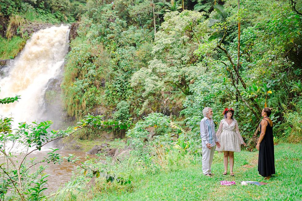 Deanna DiMichele, Kona Wedding Officiant, beginning this couple's Hawaii waterfall wedding with a traditional Hawaiian Oli (song) before starting their opening ceremony.