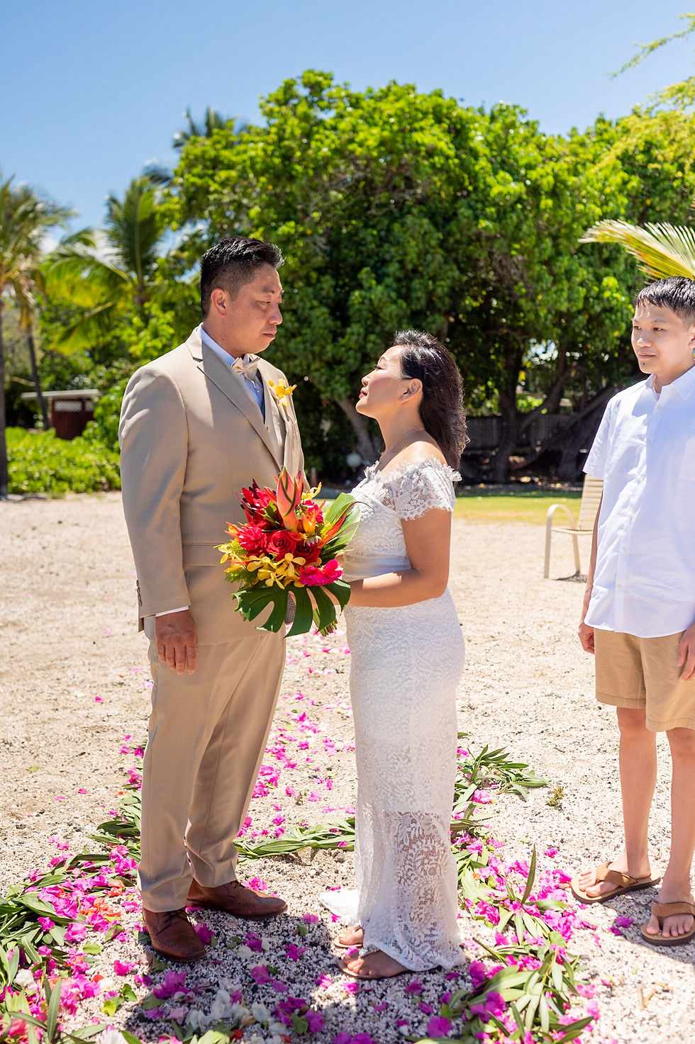 Thumbnail: Intimate ceremony moment with officiant, radiant bouquet, and tropical trees.