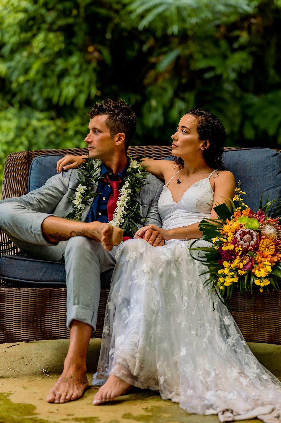 Thumbnail: Bride and groom share quiet moment on outdoor couch with island florals and love.