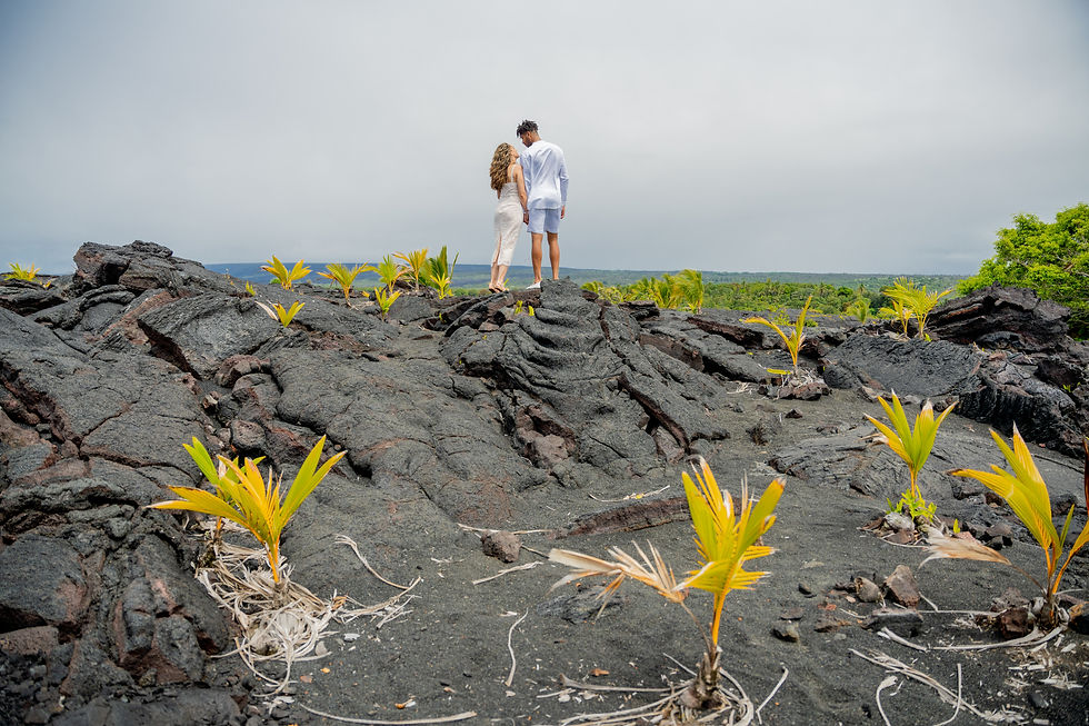 Ginelle and Tariq stand for a quiet moment in the lava fields of Kaimu Black Sand Beach, Kalapana, Hawaii after their elopement photography session with Kona Wedding Officiant.